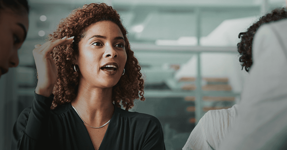 Businesswoman engaging in employee assessment discussion in a modern office setting, highlighting talent evaluation and HR solutions.